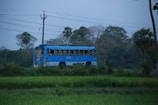 Moldukr Transit vehicle driving along a scenic route with green fields and blue skies.