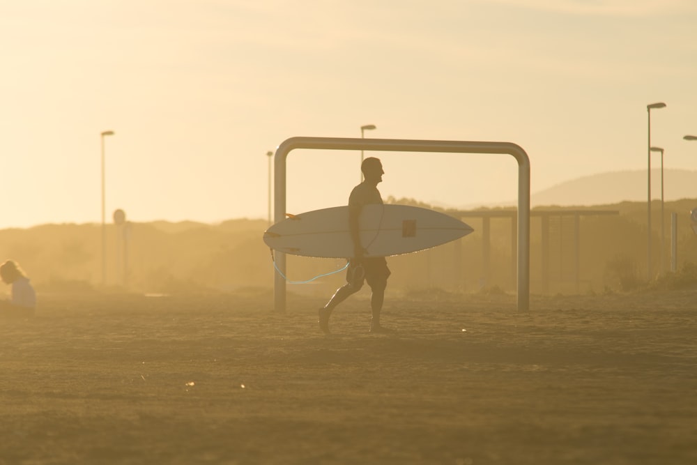 man holding surfboard