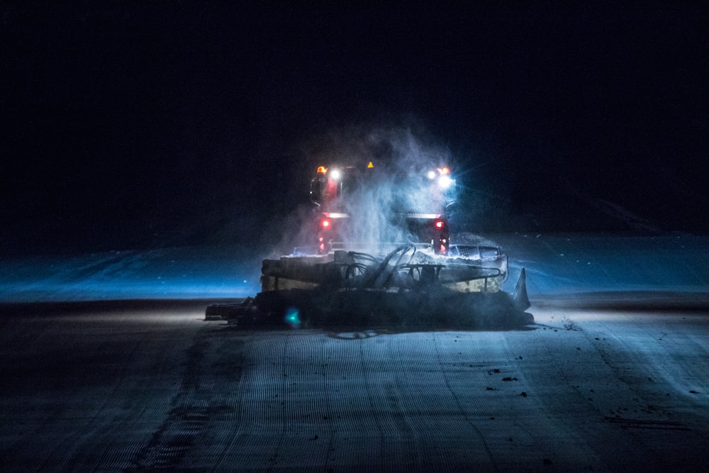 a large truck driving down a road at night