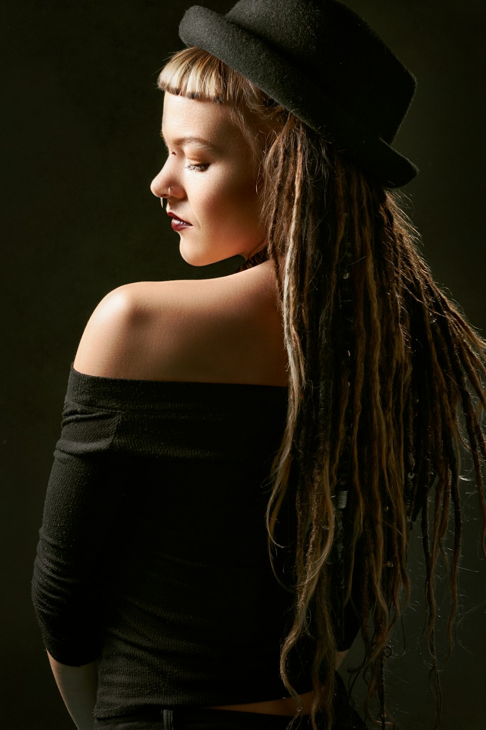 woman in black hat and black off-shoulder top