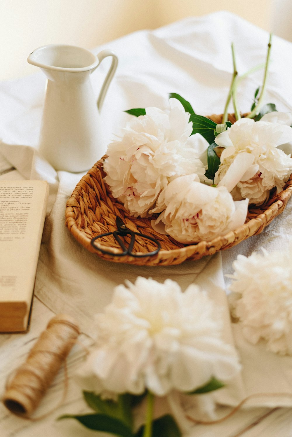 white cluster flowers on brown basket