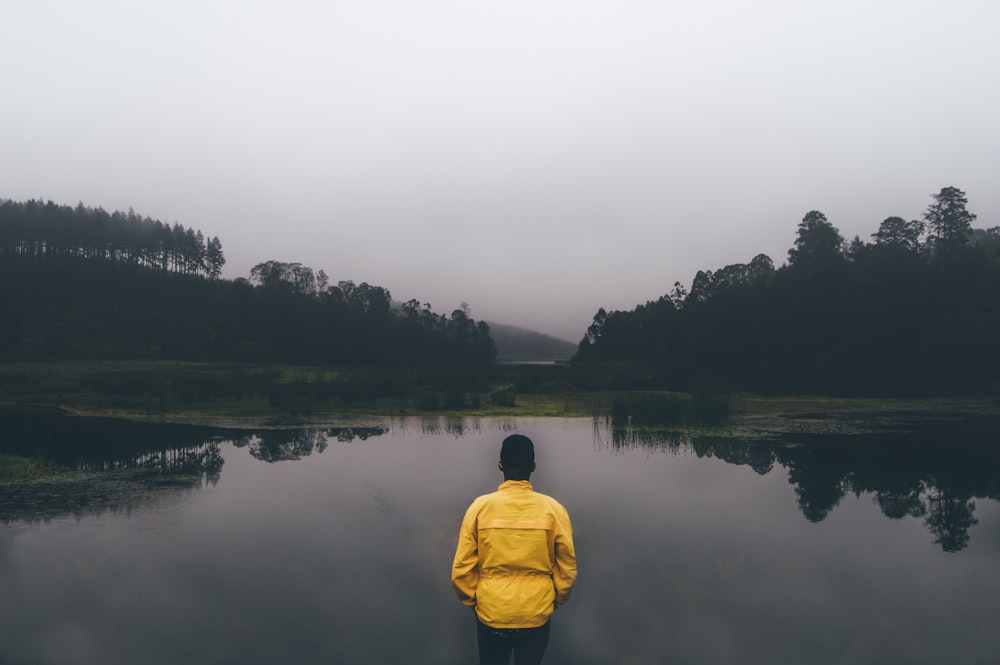 man standing in front of body of water