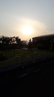 A serene sunset behind the Soul Light Embassy building, symbolizing hope and peace.