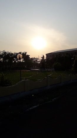 A serene sunset behind the Soul Light Embassy building, symbolizing hope and peace.