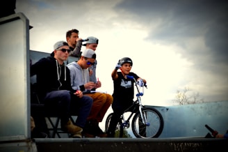 Young participants wearing safety goggles preparing water rockets on a sunny day.
