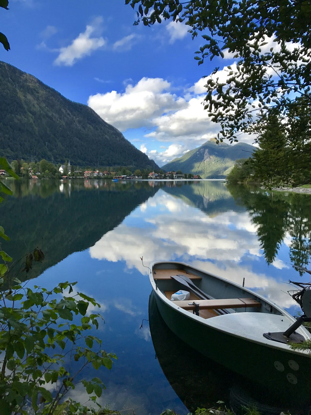 white and brown boat on calm water