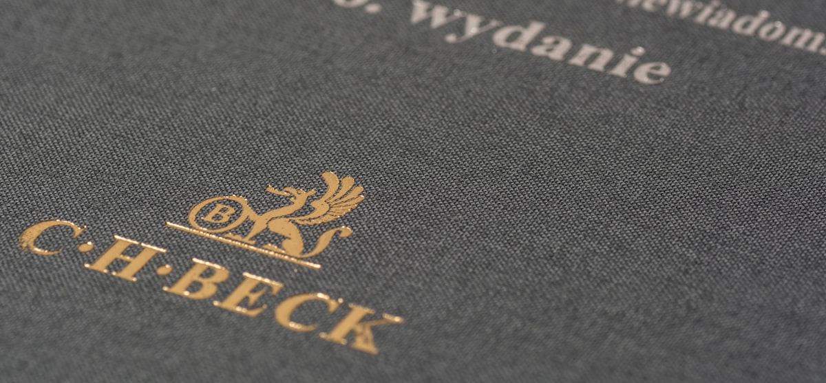Close-up of gold foil stamped book cover showing embossed lettering and premium finishing