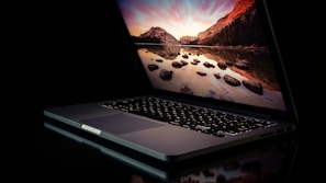 A Huawei laptop open with a stunning mountain wallpaper on screen.