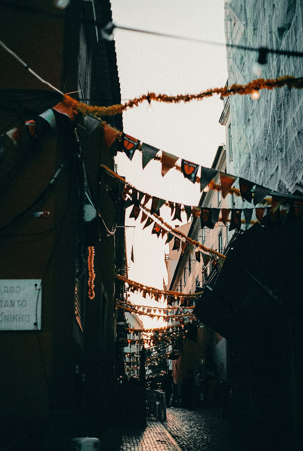 assorted-color pennant flags in between buildings