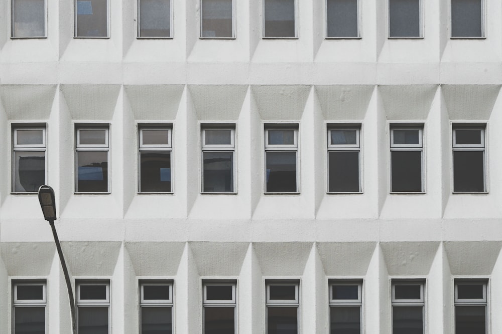 a tall white building with lots of windows