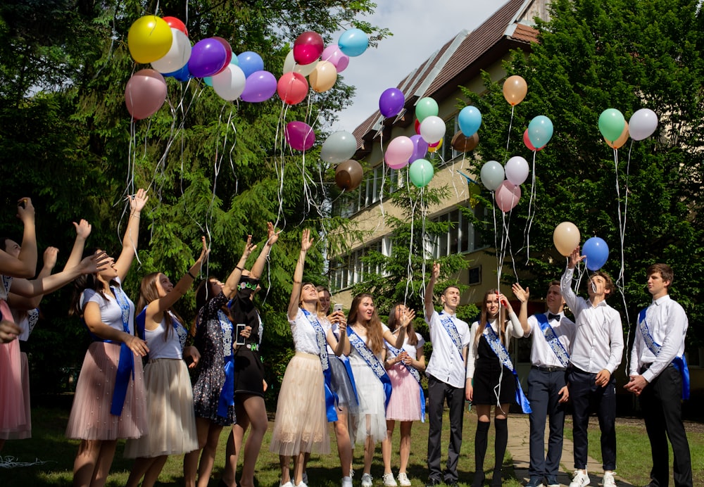 girls and boys flying a balloons