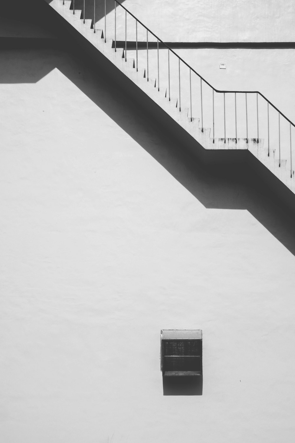 a black and white photo of a stair case