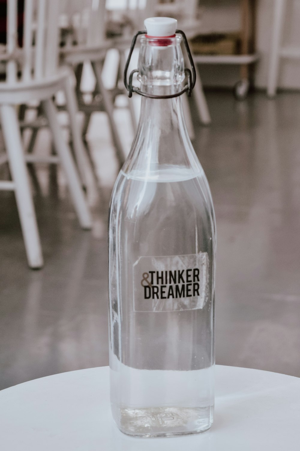 filled glass bottle on the table