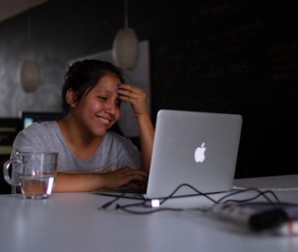 smiling woman using MacBook