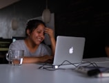 smiling woman using MacBook
