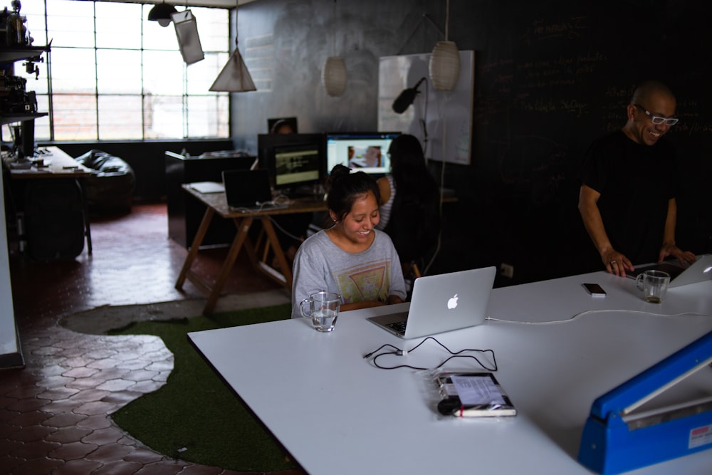 woman sitting in front of MacBook