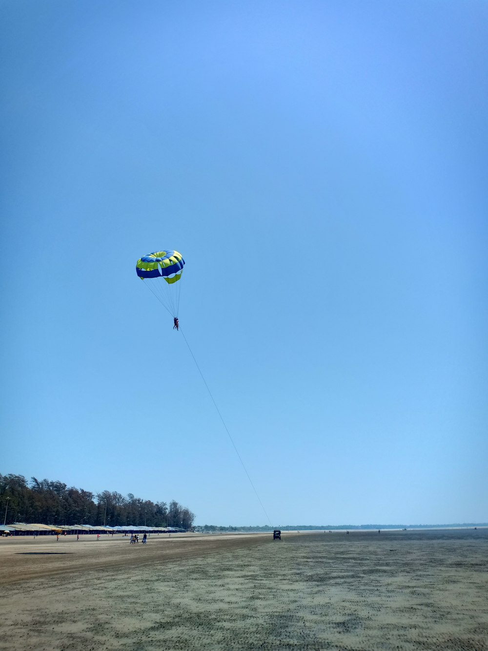 person parasailing near seashore