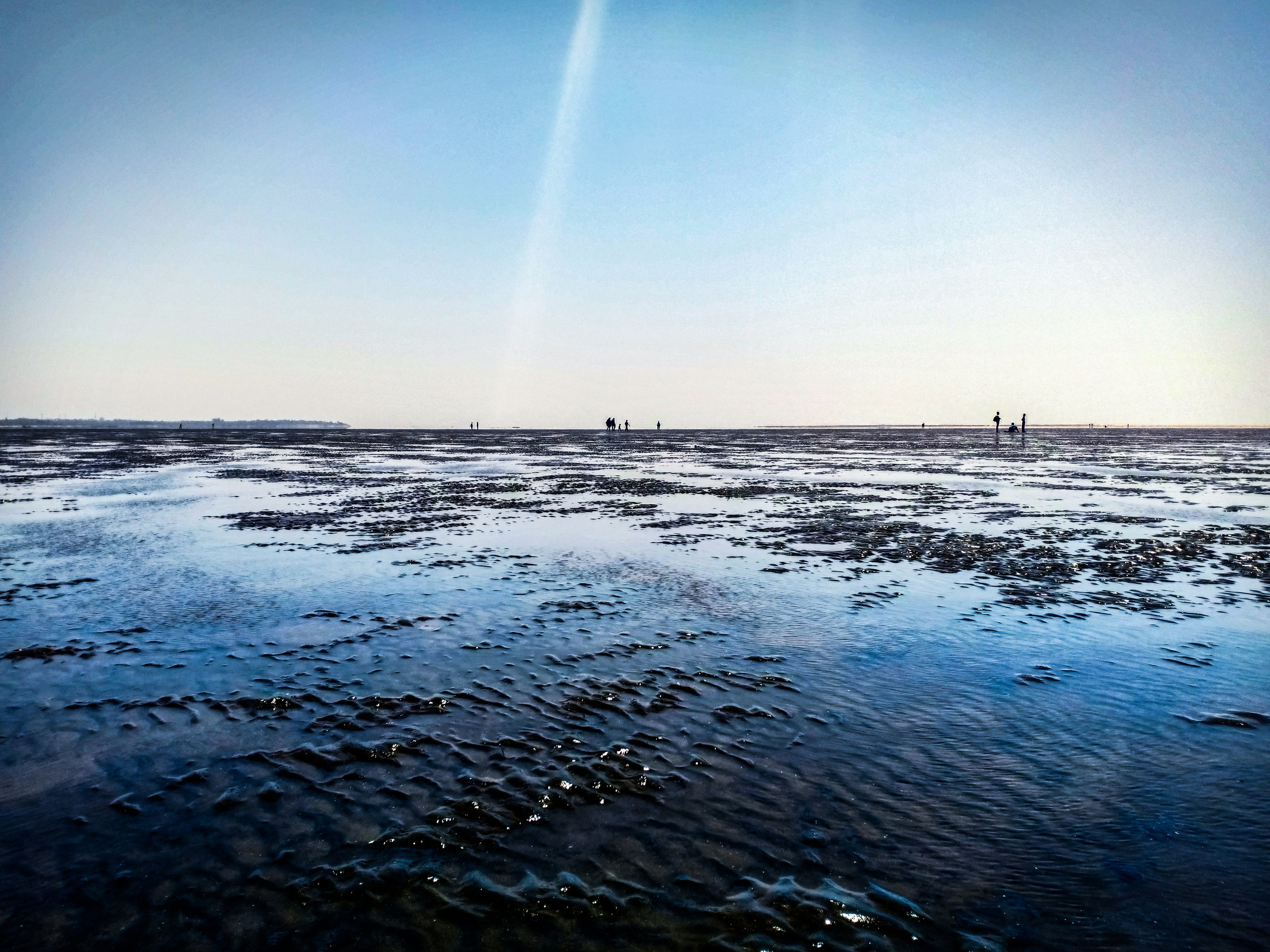 body of water under clear blue sky