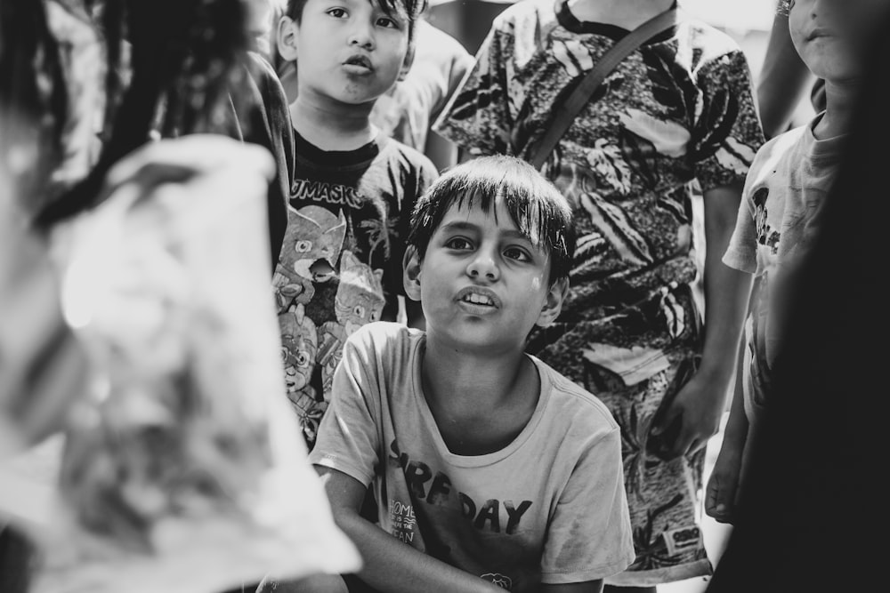 grayscale photo of boy wearing white and black crew-neck t-shirt