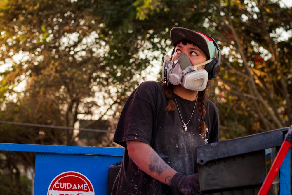 man wearing respirator looking at his upward right