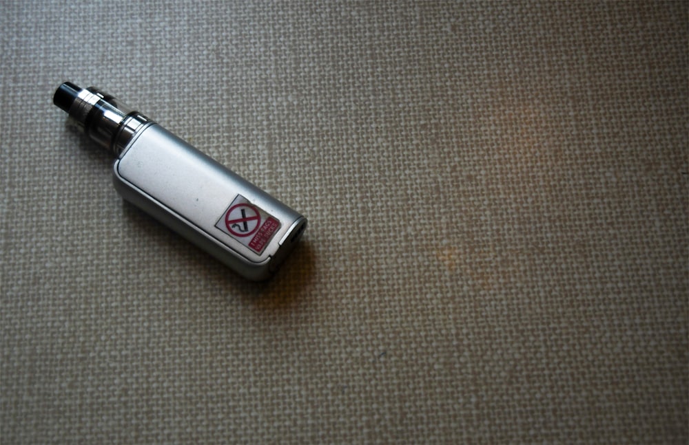 white and silver disposable lighter