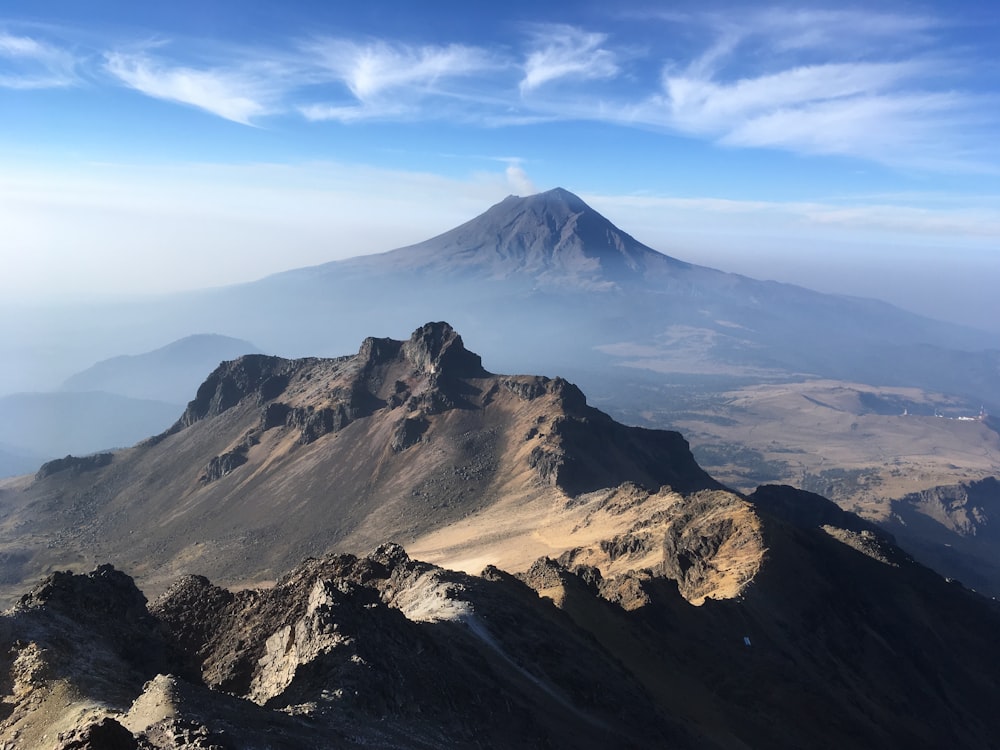 cielo blanco y azul sobre los picos de las montañas durante el día