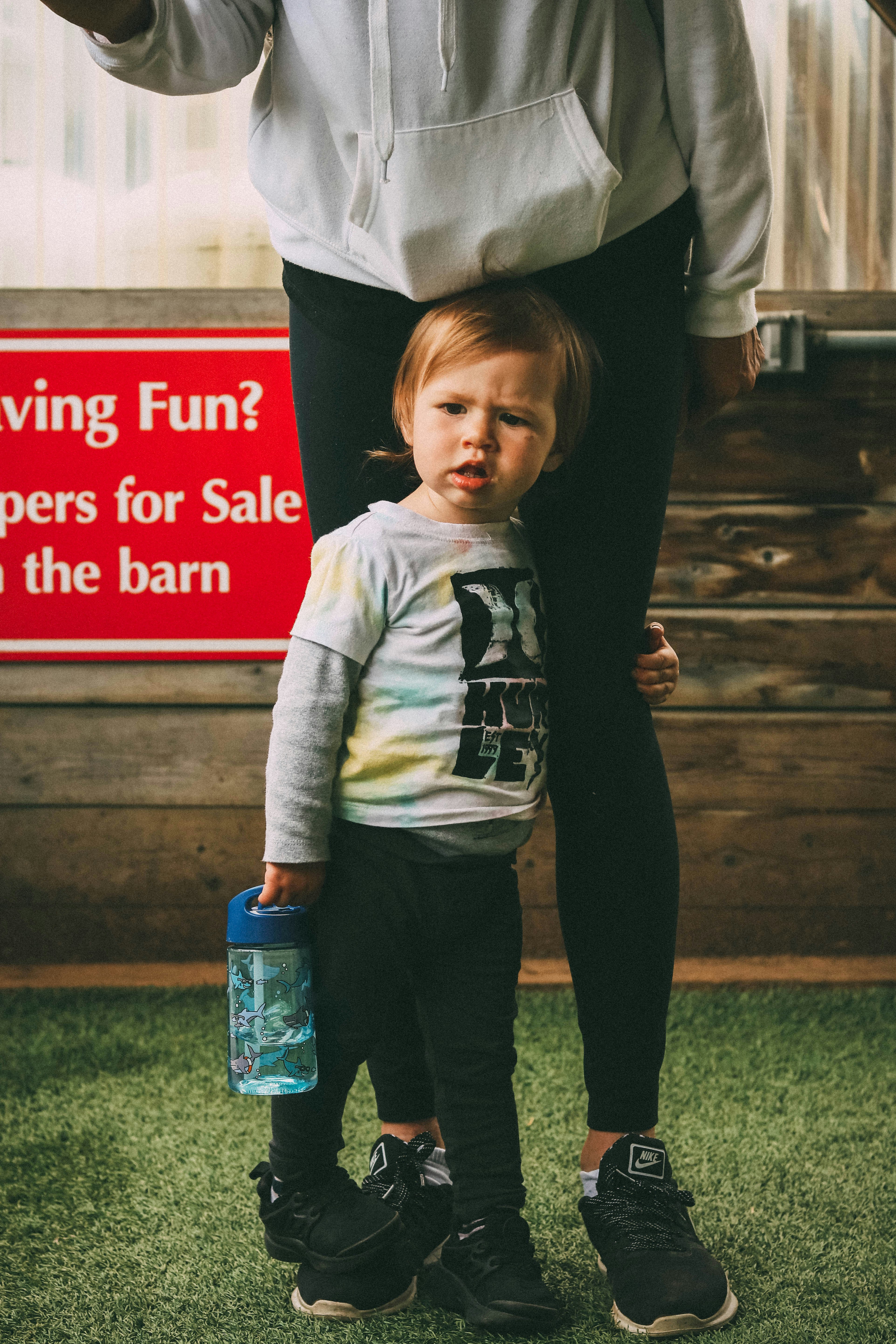 boy holding woman's left leg
