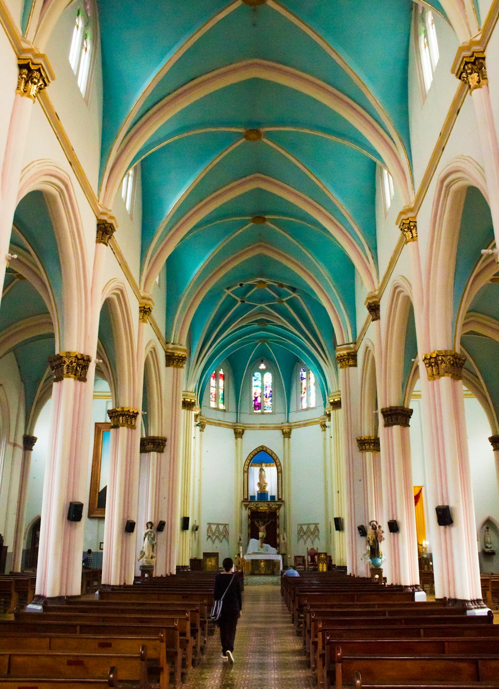 a person walking down the aisle of a church