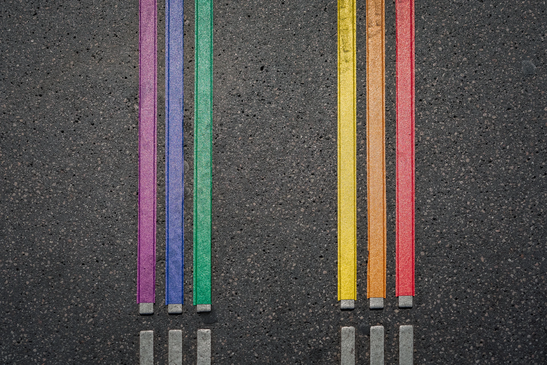 a row of colored pencils sitting next to each other