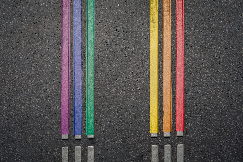 a row of colored pencils sitting next to each other