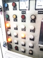 Technician testing electrical panel with a multimeter.