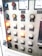 A control panel with various labeled buttons and switches, including color-coded round indicators. Labels such as insulation test, night light, lighting on, battery charge float, and failure notices are present. Some buttons are lit, indicating active status, while others remain unlit. A voltmeter gauge is visible at the top, showing voltage levels.