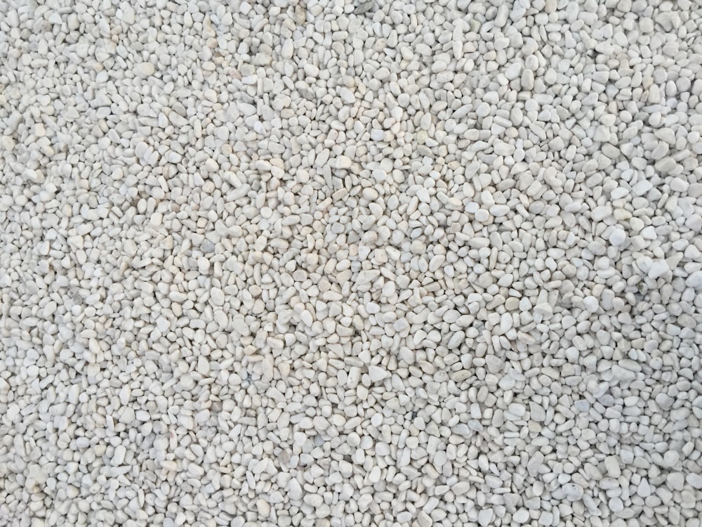 a close up of a white carpet with small rocks