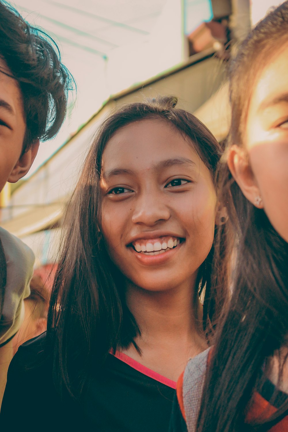 smiling woman beside persons during day