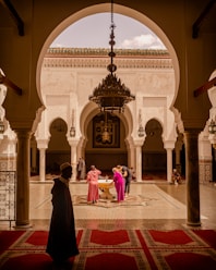 people standing beside fountain inside building during day