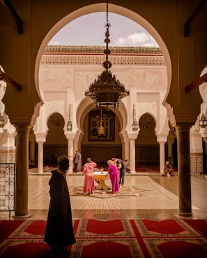 people standing beside fountain inside building during day
