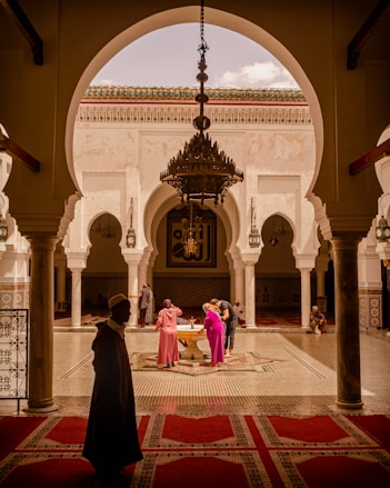 people standing beside fountain inside building during day