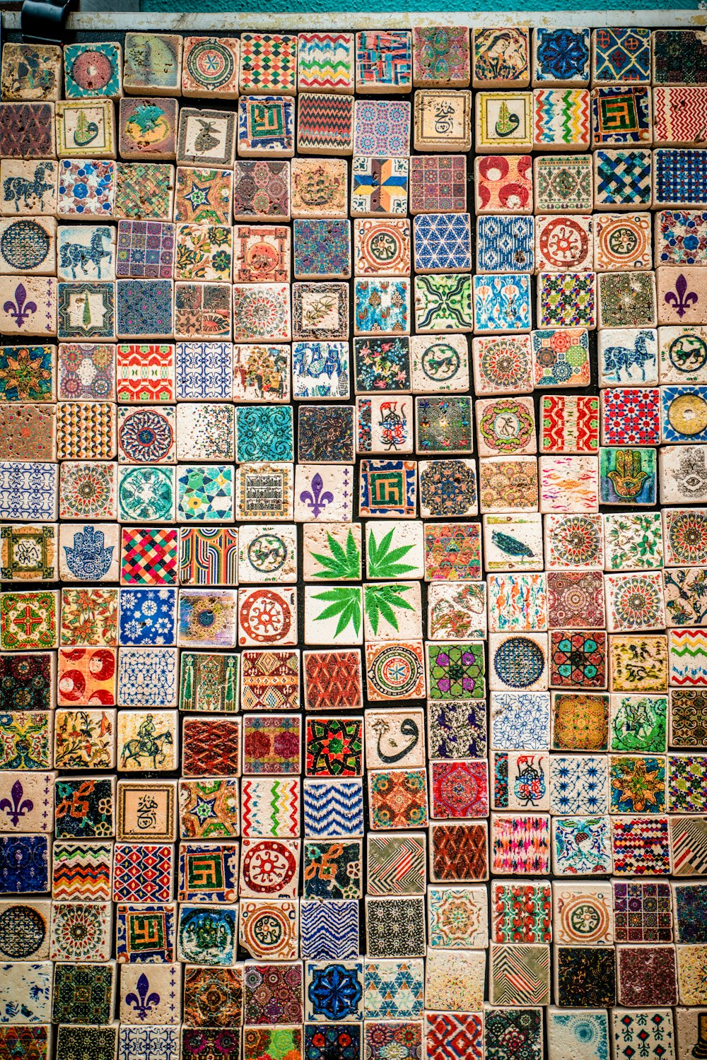 a wall covered in lots of different colored tiles