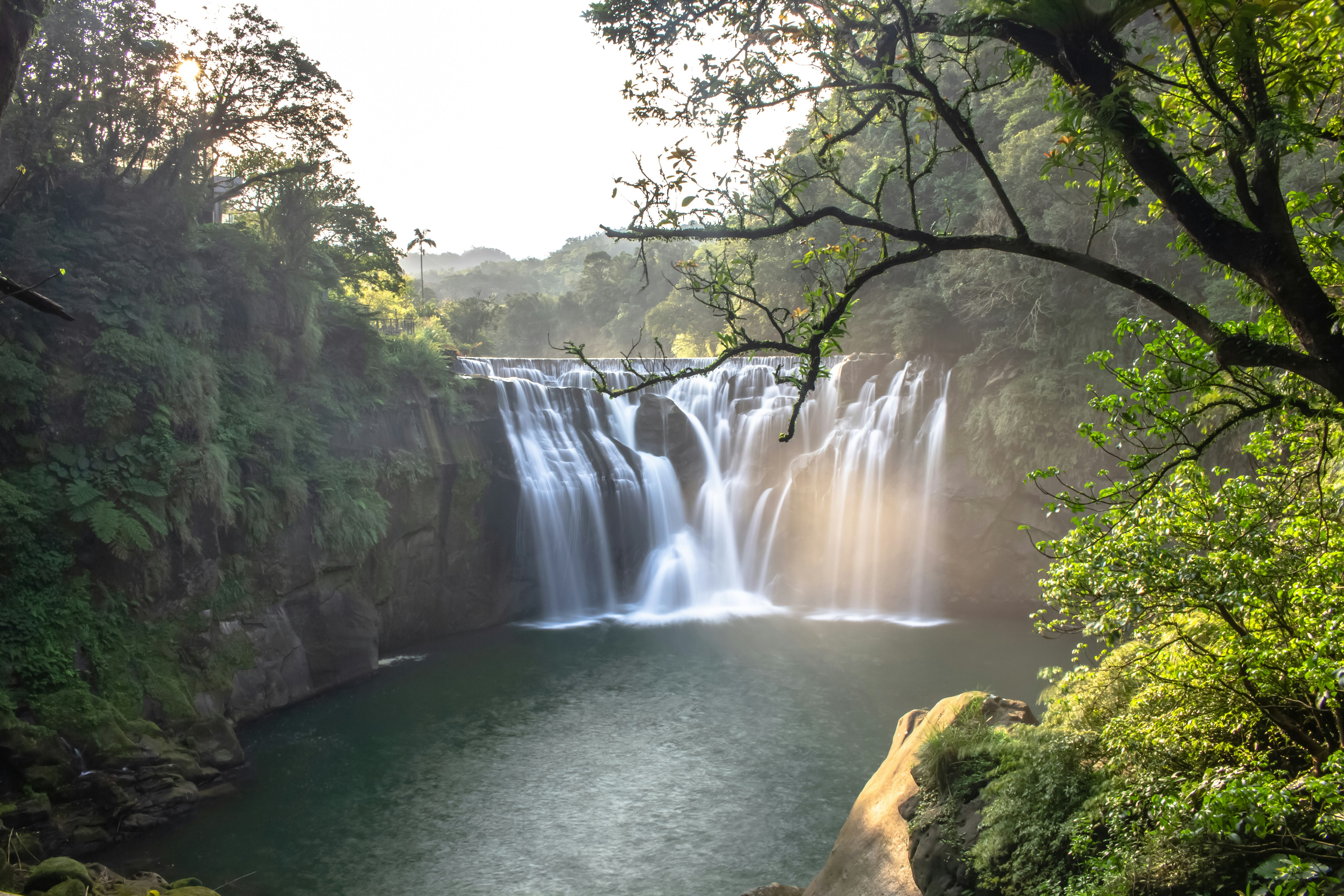 landscape photo of a waterfall and a pond