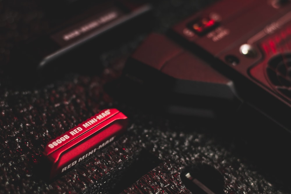 a close up of a red object on a black surface