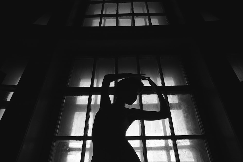 woman dancing behind glass window