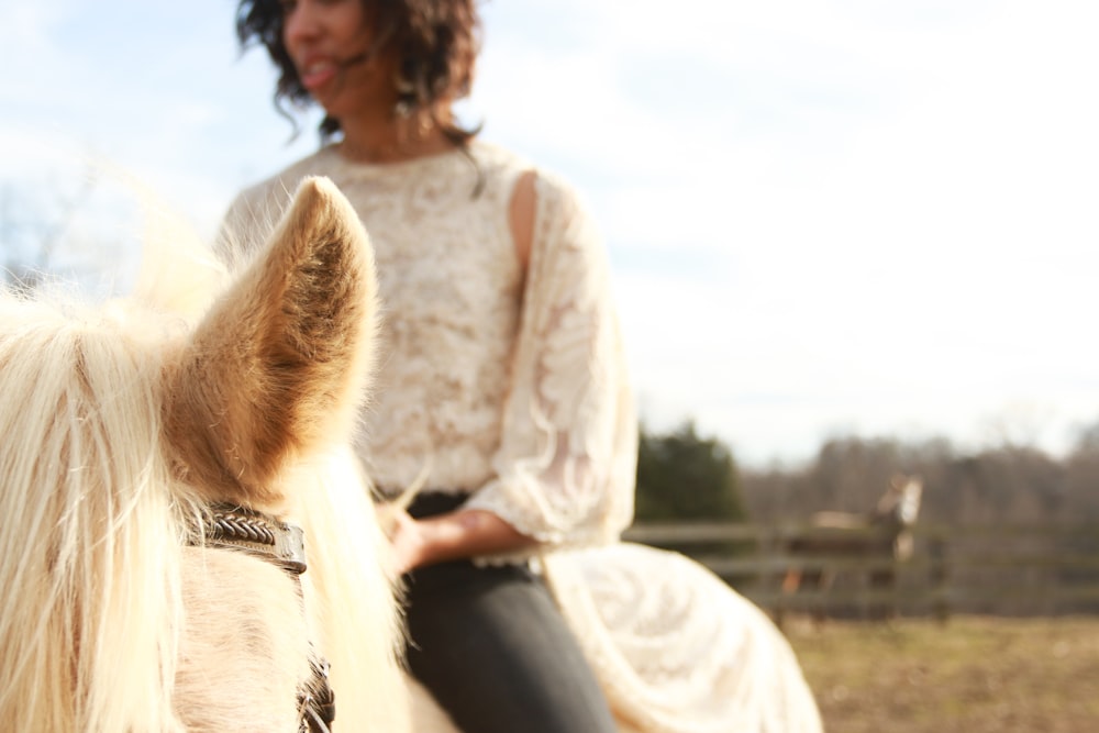 woman riding white horse