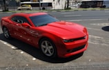 red Chevrolet coupe on road