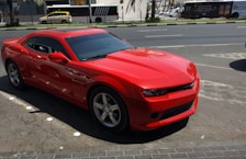 red Chevrolet coupe on road