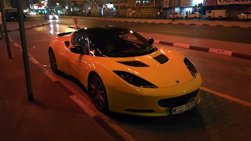 white sports car parked beside pavement