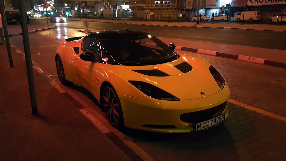 white sports car parked beside pavement