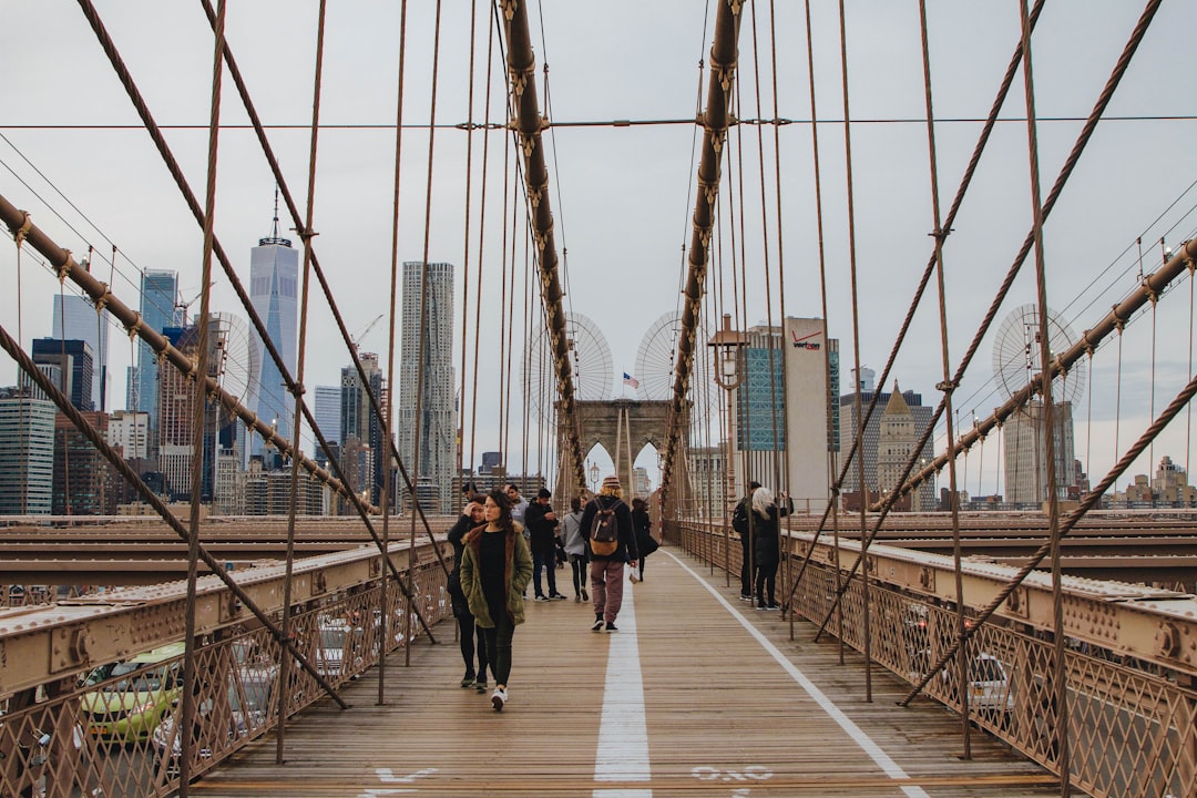 people walking on brown bridge