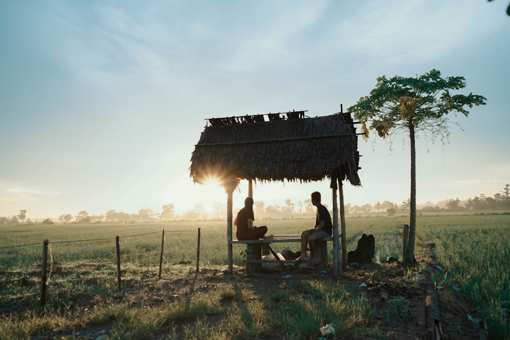 man and woman sitting on canopy