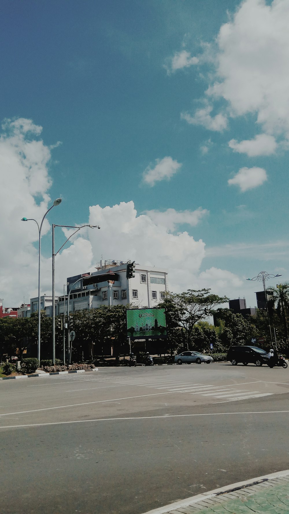 vehicles on road near building