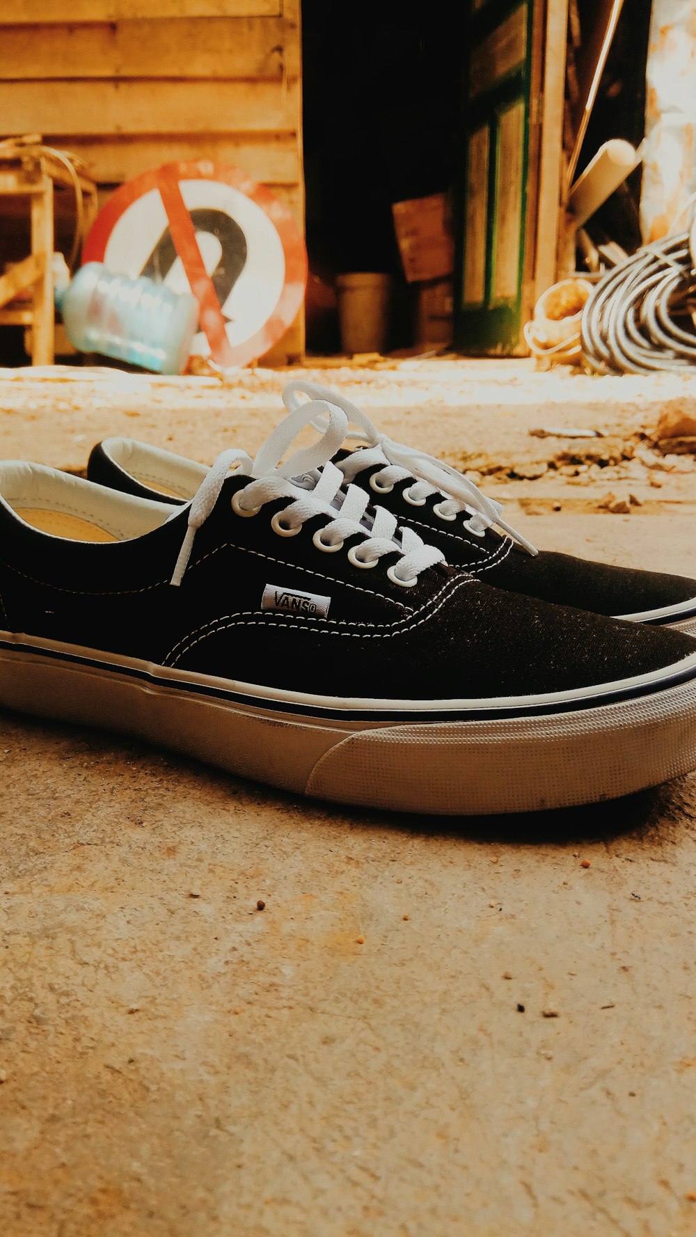 pair of black Vans low-top sneakers